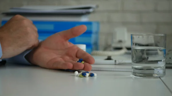 Man Hand Select and Take Pills for a Medical Treatment from the Table