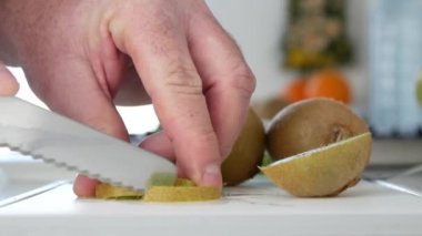 Adam taze Kivi Meyve dilim vitaminler tam bir serinletici salata hazırlanıyor Dilimleme