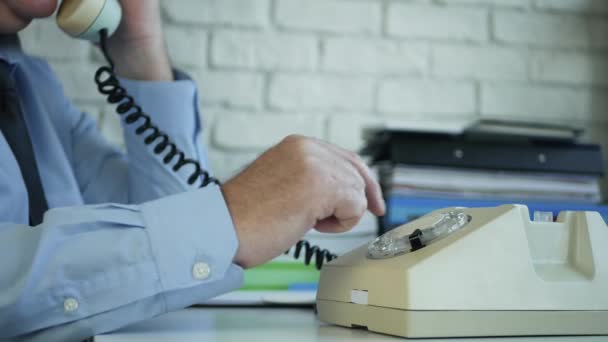 Geschäftsmann im Büroraum wählt eine Telefonnummer mit einem alten Telefon — Stockvideo