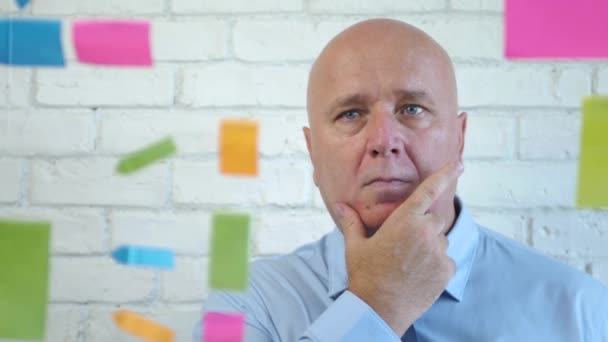 Preoccupied Businessman Looking Thoughtful to Some Colorful Sticky Notes — Stock Video