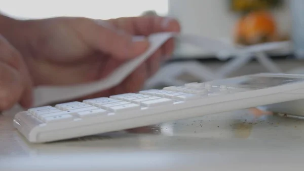 Man Calculate Daily Expenses Using Adding Machine