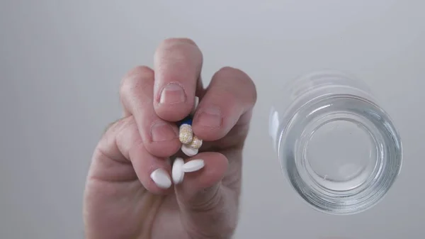 Man Select and Take Pills for a Medical Treatment from the Glass Table0 — 스톡 사진