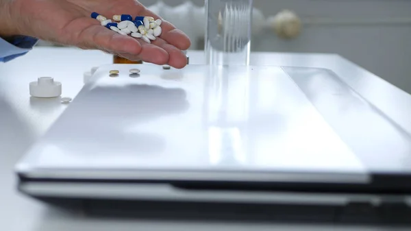 Image with a Man Taking Medical Pills Directly from a Laptop — 스톡 사진