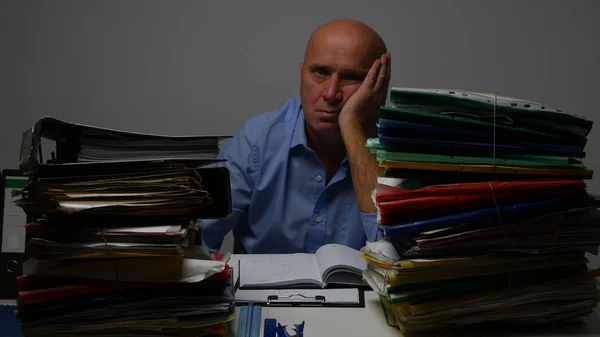 Troubled Businessperson in Accounting Archive Looking Sad to Many Documents