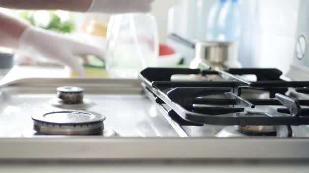 Housekeeper Wearing Protective Gloves Cleans with Spray Solution the Cooker Stove in the Kitchen — Stock Video