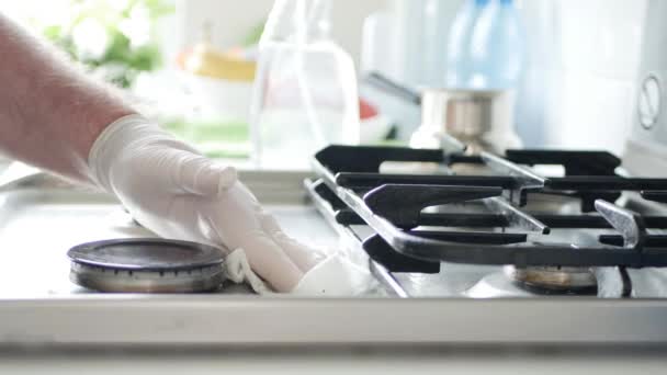 Οικιακή βοηθός φορώντας προστατευτικά γάντια καθαρίζει με διάλυμα ψεκασμού την κουζίνα μαγειρέματος — Αρχείο Βίντεο