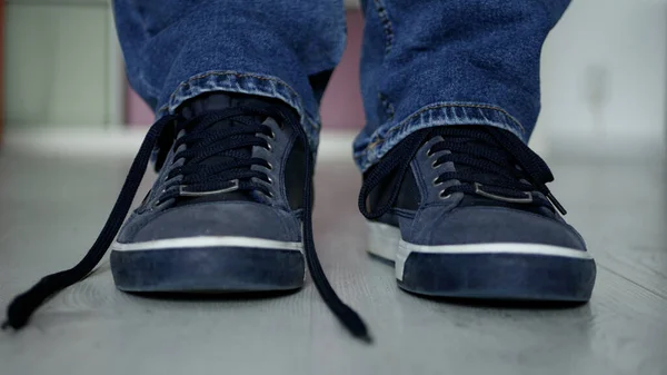 Man Preparing for a Walk with Laces Untied on His Sports Shoes Stok Foto Bebas Royalti