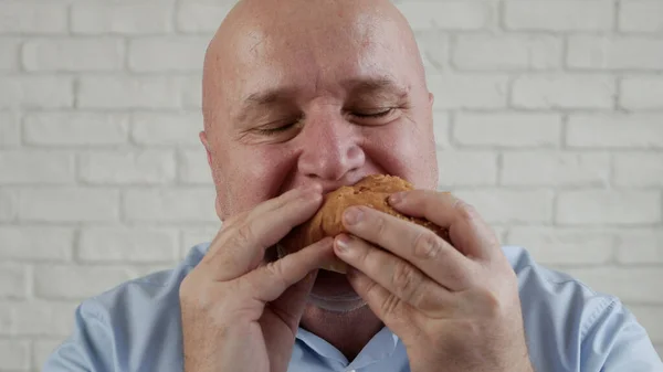 Starved Person Eating a Tasty Hamburger, Enjoy a Delicious Snack in a Fast Food Restaurant