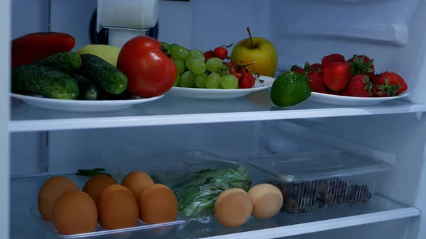 Image with an Open Refrigerator Full with  Fresh Fruits and Vegetables