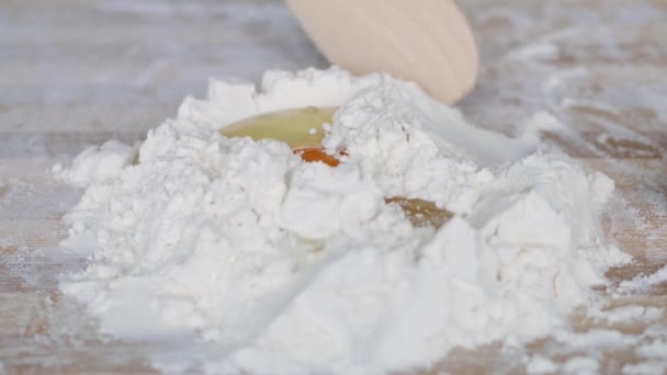 Baker Blanda vitt mjöl med ett färskt ägg på bordet Förbereda degen för bröd i ett bageri — Stockvideo
