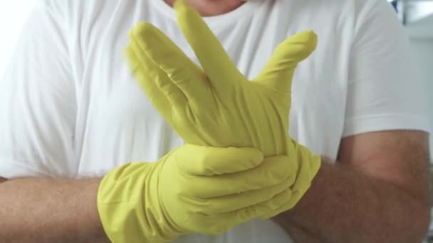 Man Puts His Yellow Protective Gloves on His Hands Preparing to Start Cleaning in the Kitchen and Bathroom — Stock Video