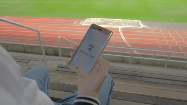 Smartphone connecting to WiFi on a stadium — Stock Video