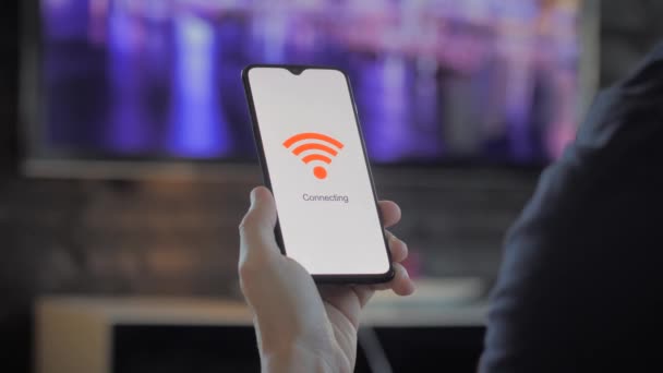 Hombre sosteniendo un smartphone que se conecta a wifi — Vídeos de Stock
