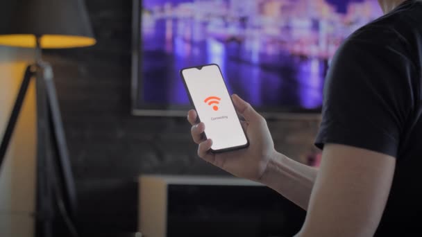 Uomo in possesso di uno smartphone che si connette al wifi — Video Stock