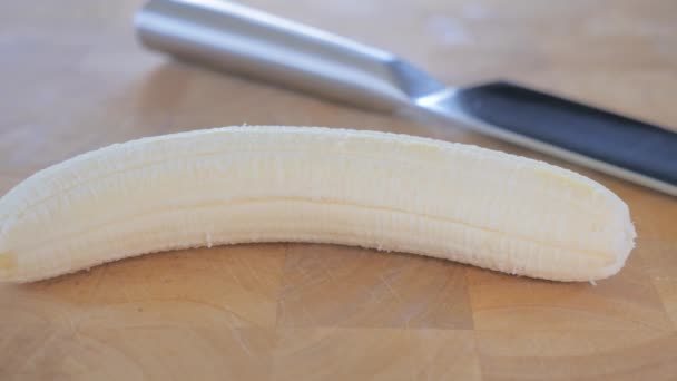 Primo piano di una banana e un coltello su tagliere . — Video Stock