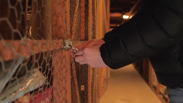 Man opens a combination lock on a storage room — Stock Video