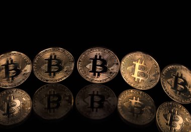 Bitcoins btc bit-sikke siyah bir yansıtıcı arka plan üzerinde durmak. Kripto cyberspace birimiyle ödeme sistemi olarak.