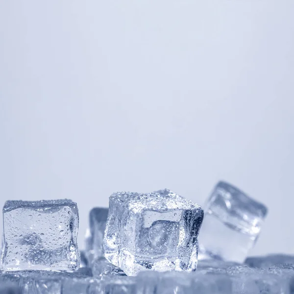 Cubes of ice covered with water drops. Frozen water in form of a cube, ice. Critically pure ice.