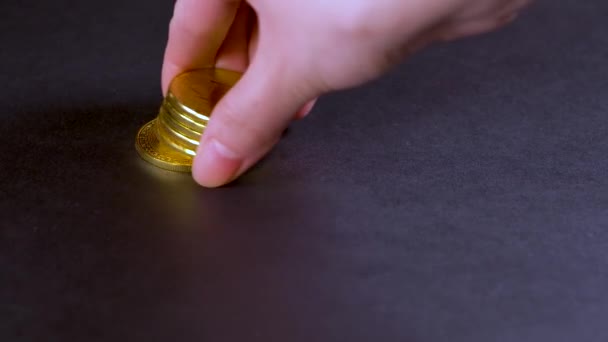 Man Lays Out Bitcoin Coins Takes One Coin Pile — Stock Video