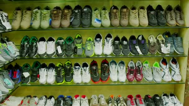 Sale of shoes in supermarket shopping mall summer sneakers on shelves in shoes store stylish footwear — Stock Video