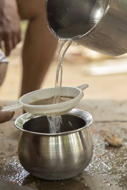 Adam kabın içine hindistan cevizi suyu döker ve boşaltır.