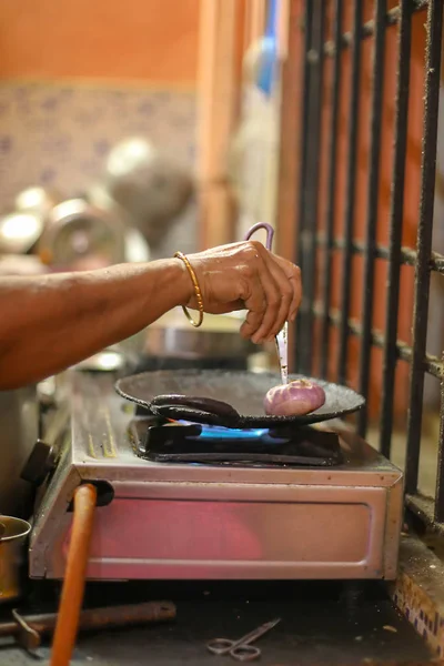 Женщина, стоящая рядом с плитой и готовящая ужин на кухне. Подготовка концепции индийской кухни . — стоковое фото