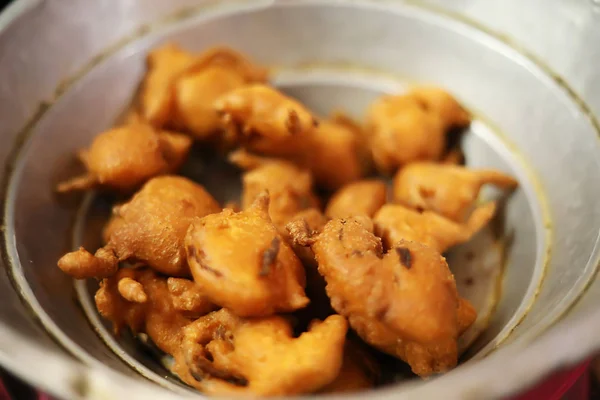 Индийская еда на вынос, пряный лук бхаджи на тарелке — стоковое фото