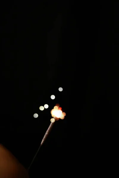 Queimando fogos de artifício sparkler contra um fundo preto — Fotografia de Stock