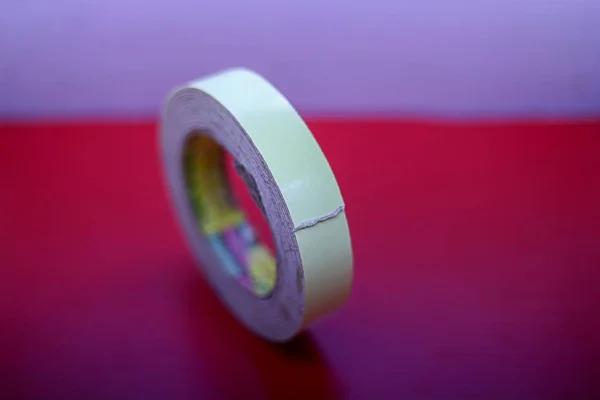 Double-sided tape isolated on red background — Stock Photo, Image