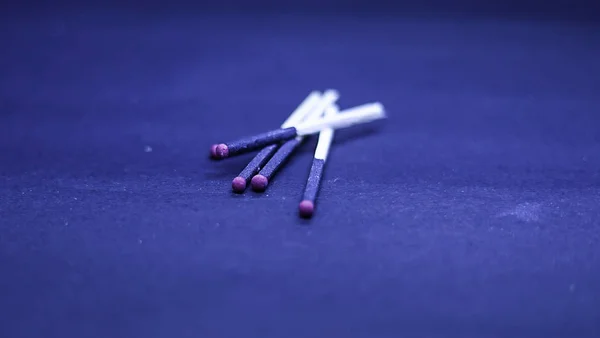 Close up of a Matchstick Over Dark Blue Background . — стоковое фото