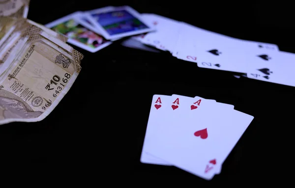 Играть в покер, играть в карты с индийской рупии банкноты на черном фоне — стоковое фото