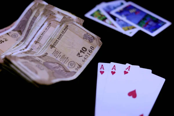 Playing Cards and Indian Currency Rupee bank notes on black background — Stock Photo, Image