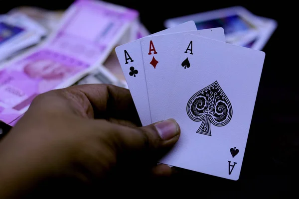 Hand holds three aces on a black background. Close up. — Stock Photo, Image