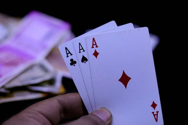 Hand holds three aces on a black background. Close up. — Stock Photo, Image