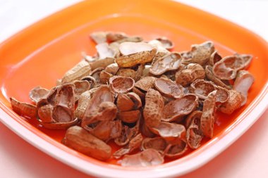 Çiğ fıstık üst görünümü turuncu plaka arka planında izole