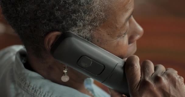 Older black woman talking on a cordless landline phone - OTS — Stock Video