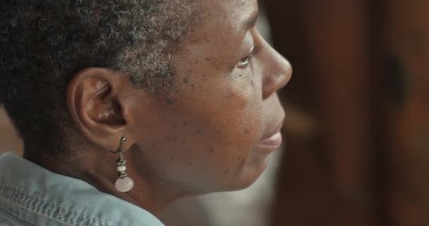 Hermosa mujer anciana afroamericana sentada y escuchando música esperando — Vídeos de Stock