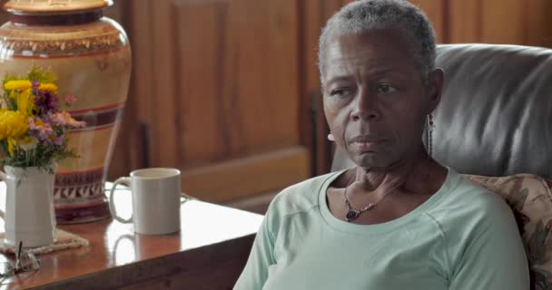 Ledsen, orolig, äldre senior svart kvinna sitter och tittar på kameran — Stockvideo