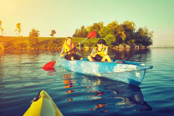 Kayaking and canoeing with family. Children on canoe. Family on kayak ride.