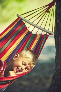 Hamakta, bahçede oturan çocuk oynarken komik küçük çocuk