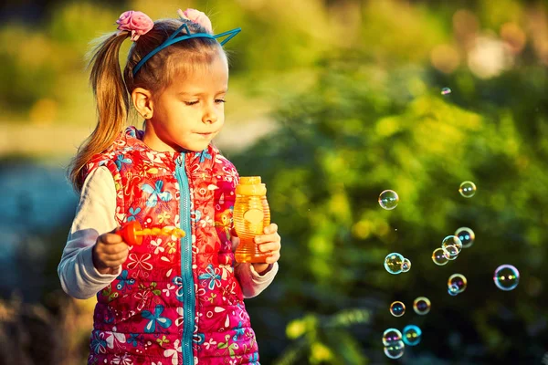 かわいい女の子と秋の公園でシャボン玉 — ストック写真