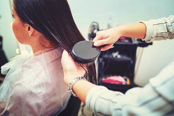 Close-up of hair dryer for hair drying, concept hair salon, female stylist.