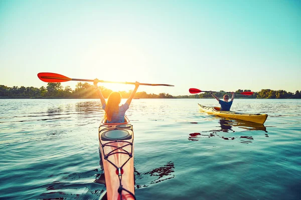 People kayak during sunset in the background. Have fun in your f — Stock Photo, Image