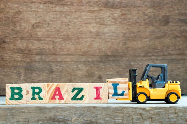 Yellow Toy Forklift Hold Letter Block Complete Word Brazil Wood — Stock Photo, Image