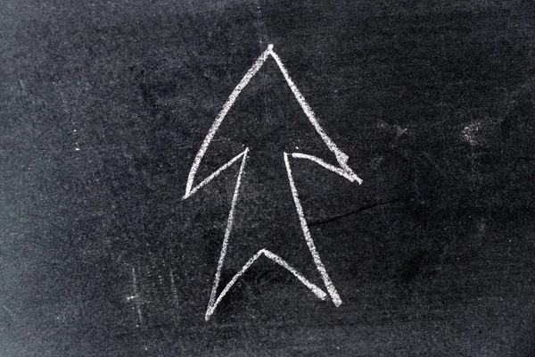 White chalk drawing in arrow shape on black board background