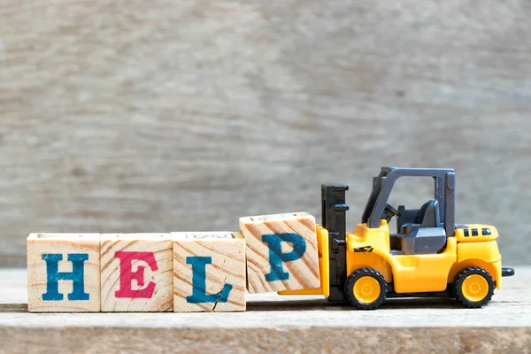 Toy Forklift Hold Letter Block Complete Word Help Wood Background — Stock Photo, Image