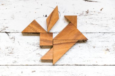 Tangram bulmacanın eski beyaz ahşap zemin üzerinde tavşan şeklinde