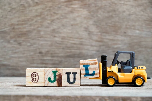 Toy Forklift Hold Block Complete Word Jul Wood Background Concept — Stock Photo, Image