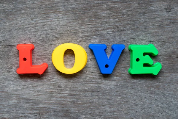 Colorful Plastic Alphabet Word Love Wood Background — Stock Photo, Image