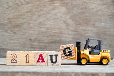 Oyuncak forklift tutun blok G ahşap arka plan üzerinde tam word 21 Ağustos (kavramı için takvim tarihi ay Ağustos)
